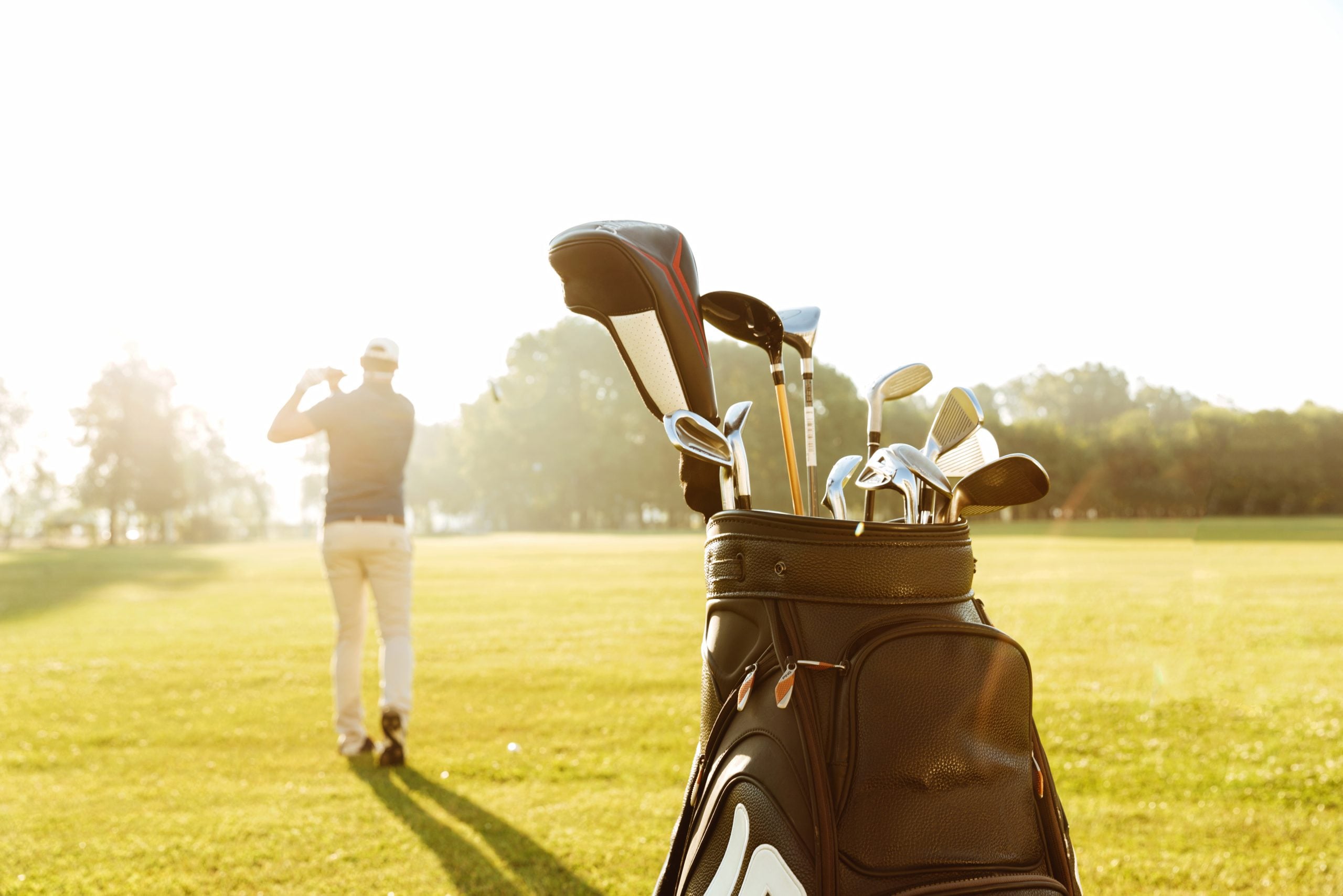 Background image of golfer and golf clubs